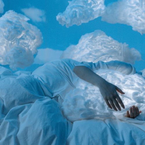 Person in a calm, meditative state, surrounded by soft light.